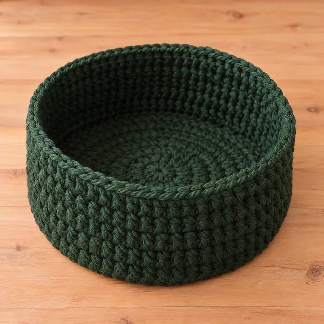 A cylindrical green crochet structure.
