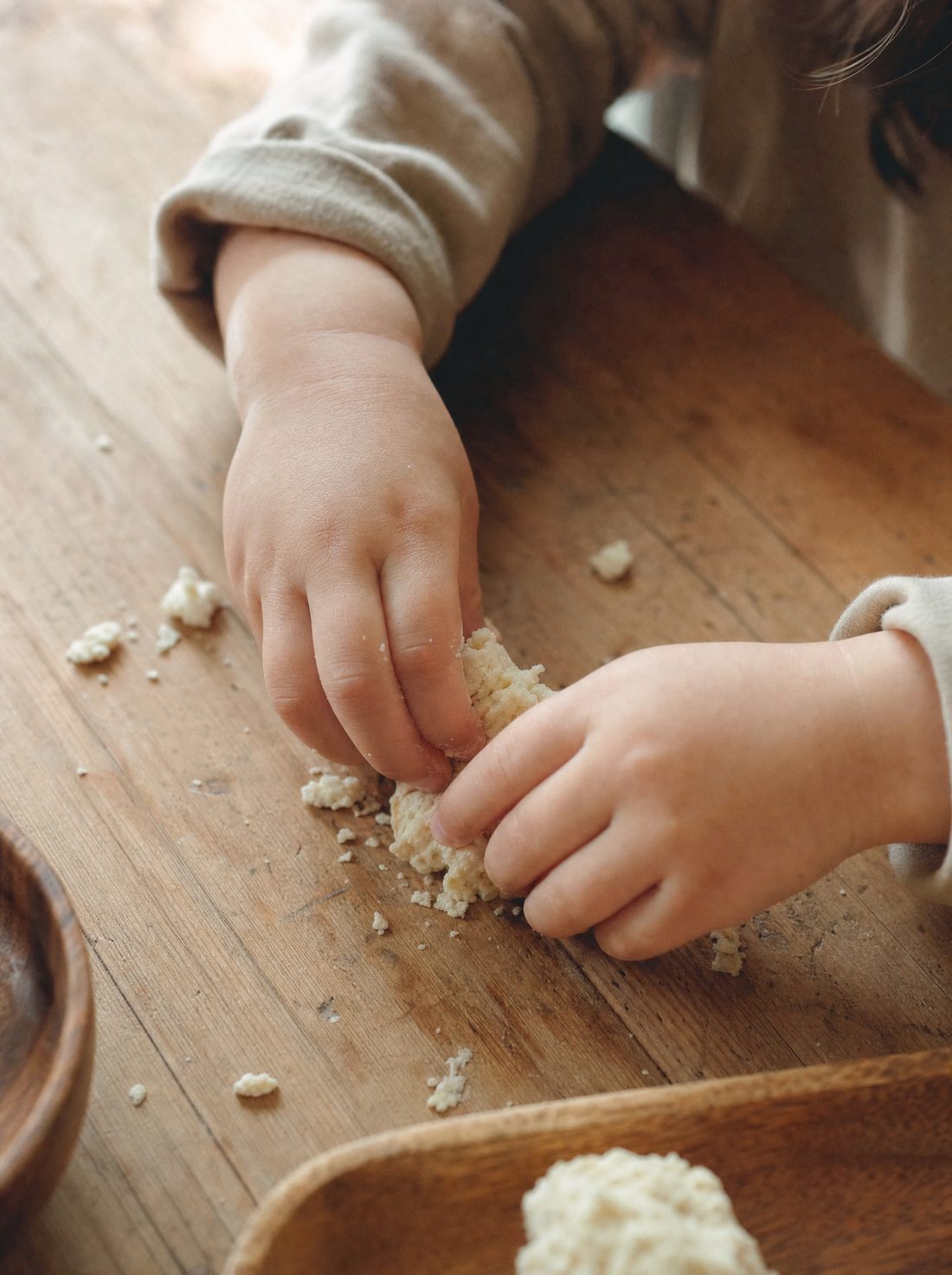 A child's hands exploring food